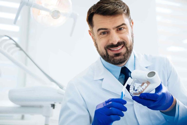 dentist holding artificial teeth