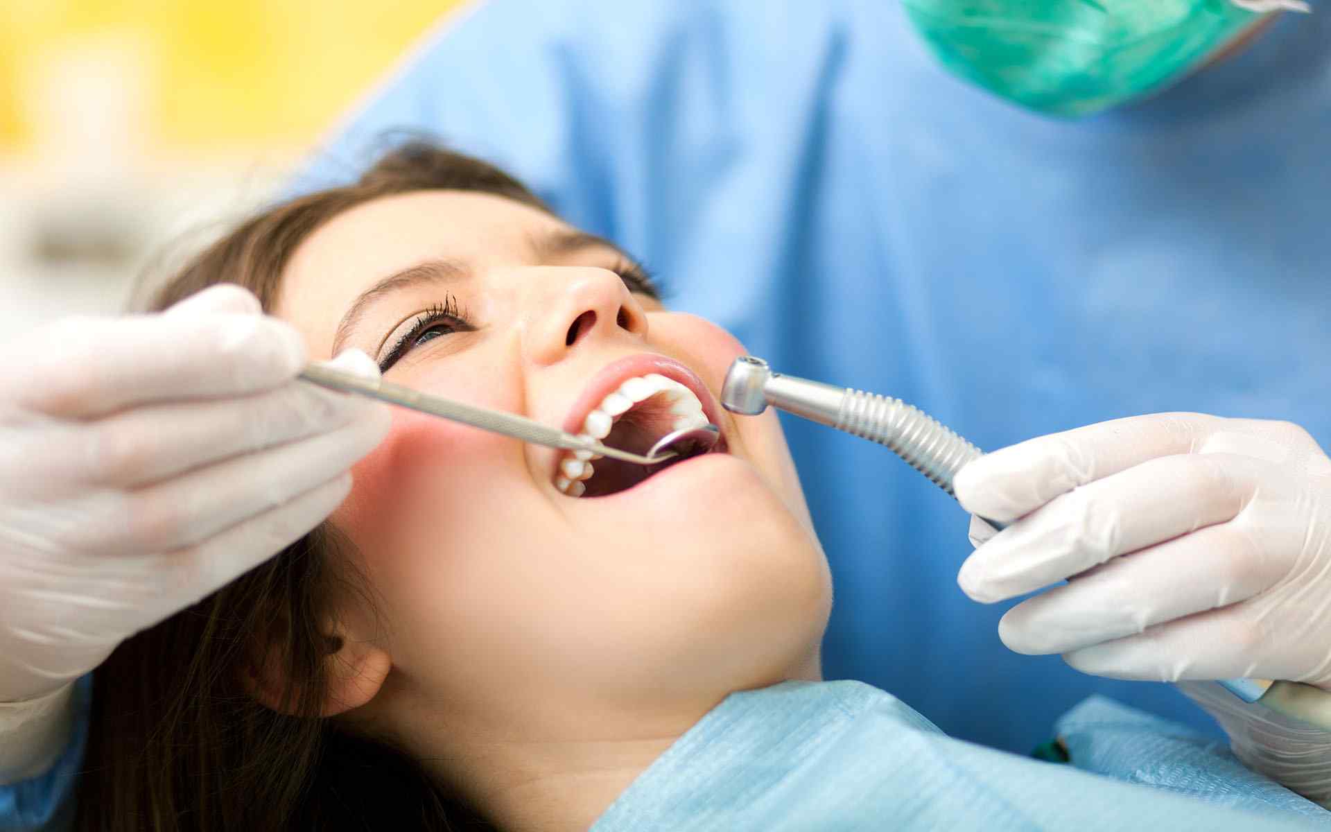 Checking young lady teeth