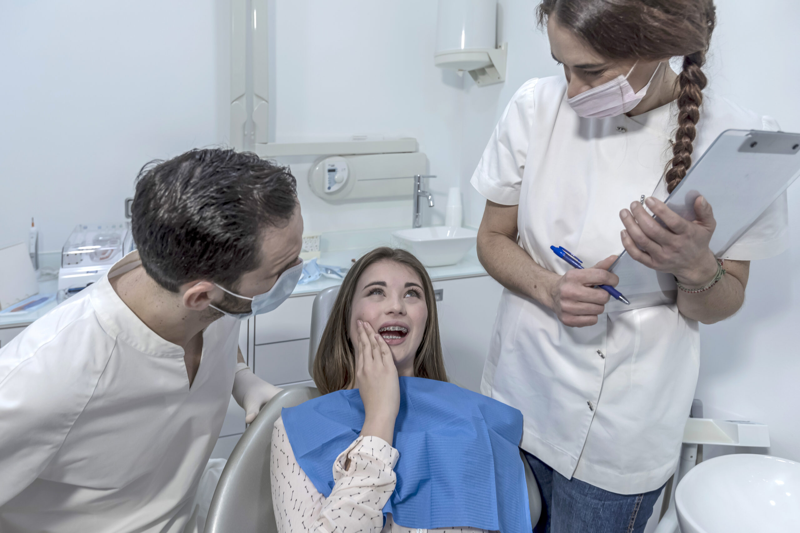 Little boy having toothache, sitting in dental chair during teeth examination