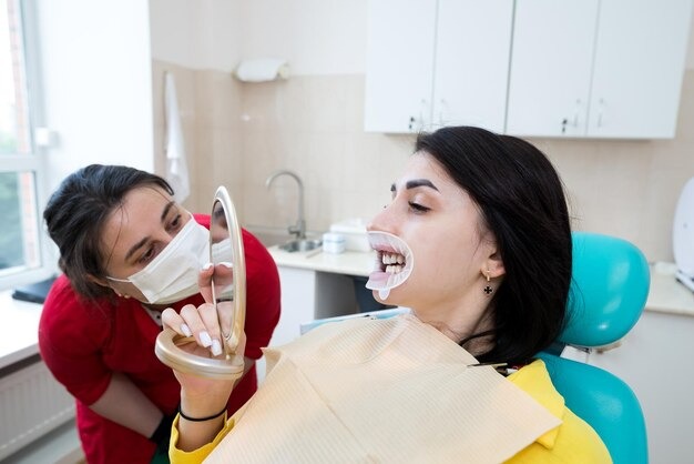 imgi_160_dentist-demonstrates-patients-perfect-smile-after-implanting-dental-veneers-teeth-whitening_357889-8503